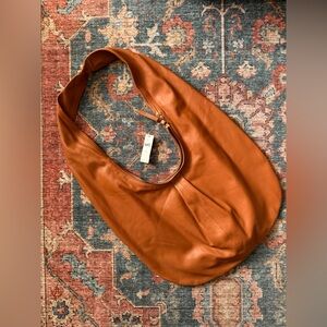 NWT Anthropologie sling cognac handbag